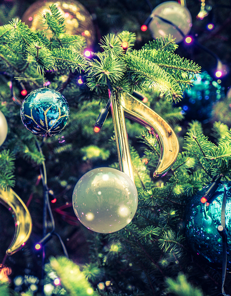 Music note shaped christmas ornament hanging on a tree