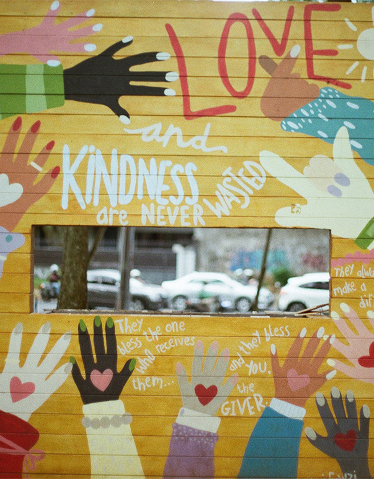 images of a board that shows hands and fingers with images of hearts on the back of the hands with words like love kindness